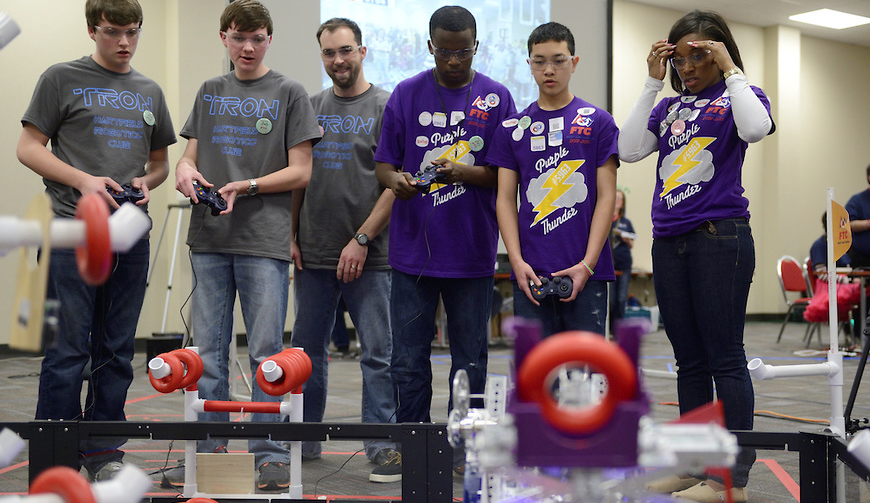 An obstacle course challenges the maneuvering capabilities of the students' robotic designs.