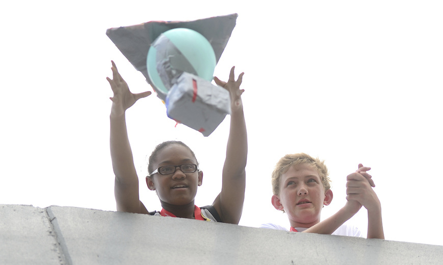 In the egg drop, students devise solutions to protect an egg as it falls from a great distance.