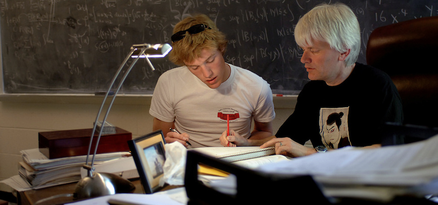 Gerard Buske, principal investigator of the math department's GAANN award, meets with a student.