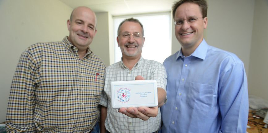 Dwight Waddell (left), Paul Goggans (center), and Greg Snyder (right) demonstrate a prototype of their device.