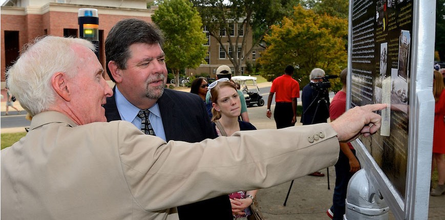 Andy Mullins (left) and Morris Stocks (right) view a Freedom Trail Marker.